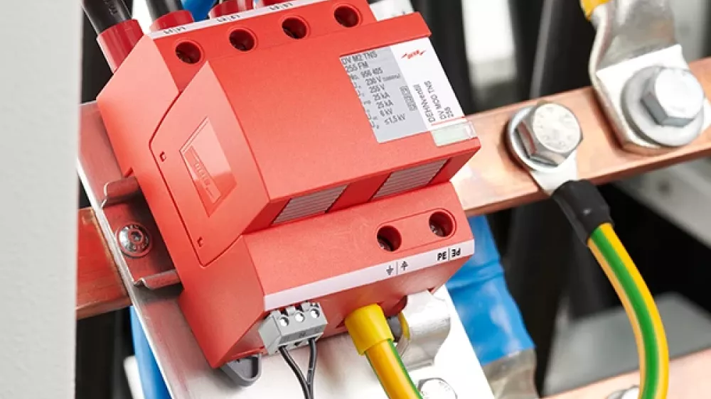 Red surge arrester, mounted and wired in a sub-distribution cabinet.